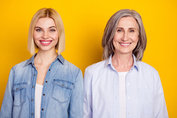 Photo portrait of mother and daughter wearing stylish outfit smiling isolated vibrant yellow color background