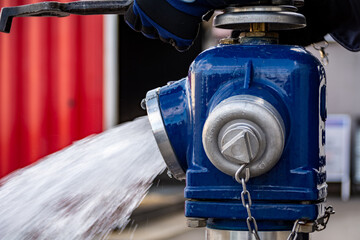 Close up of Water flowing from in open blue fire hydrant