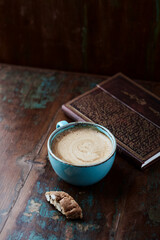 Cappuccino and Cantuccini (Italian cookie) on dark wooden background. Copy space.