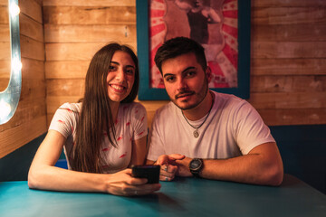Closeup shot of a white Caucasian girl and a boy showing peace signs