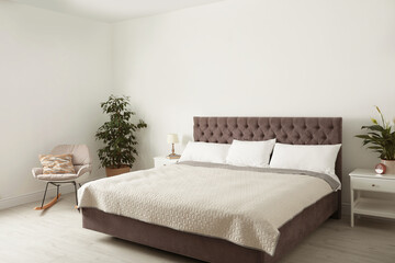 Elegant interior of contemporary bedroom with plants