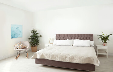 Elegant interior of contemporary bedroom with plants