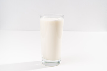 a glass of milk on a white background. selling farm products. Place for the inscription.