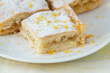 Lemon pie with filling, icing sugar and lemon zest