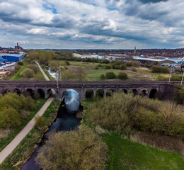 An aerial view looking down over the Far Cotton Railway viaduct in Northampton, UK on a Spring day