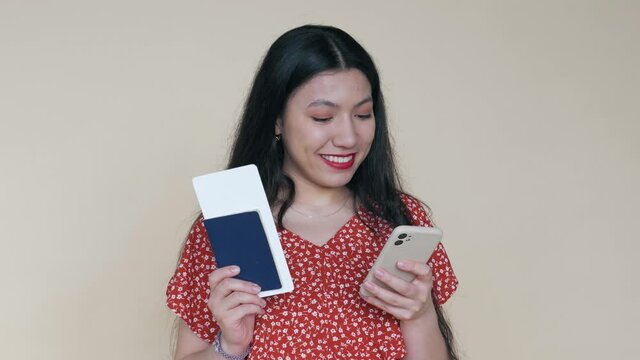 Beautiful woman showing how to travel, using flight ticket, passport and smartphone. Information for travellers how to fill a flight form before travelling vacation. Plane ticket application on phone