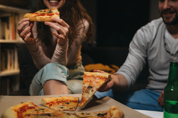 close up friends eating pizza. unrecognizable people