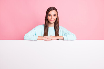 Photo of beautiful young woman wear blue sweater stand behind empty space placard isolated on...