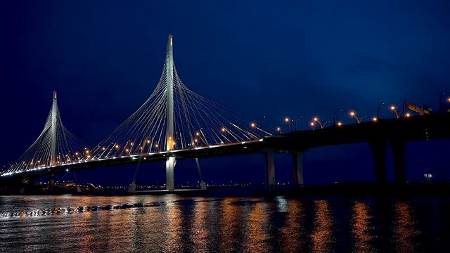 Saint Petersburg, Russia, April-10 2021: ZSD bridge with illumination across the Neva River in St. Petersburg at night.