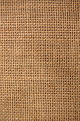 Texture background of the surface of brown burlap woven in a cage of coarse threads