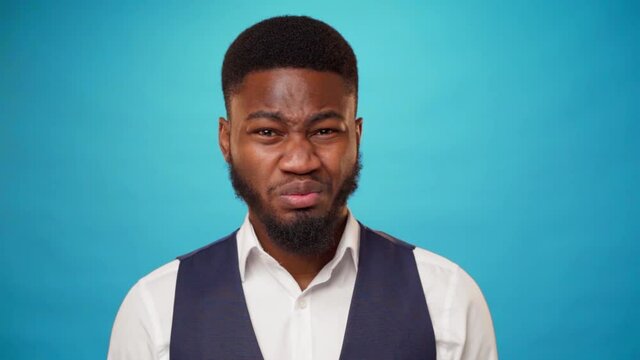 Young bearded african man expressing disgust and aversion
