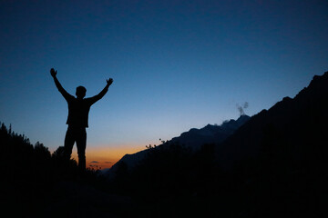 silhouette of a person on a mountain top