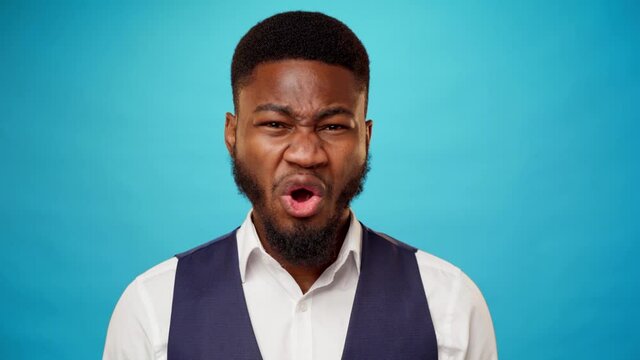 Young bearded african man expressing disgust and aversion