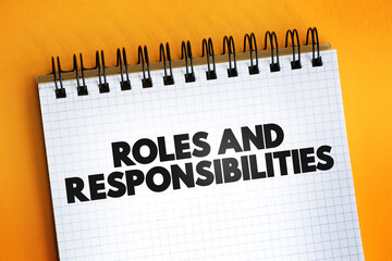 Roles And Responsibilities text quote on notepad, concept background.