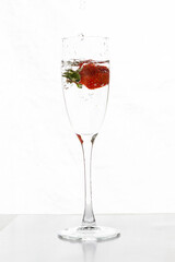 Filling up the champagne glass with strawberry isolated on a white background copy space