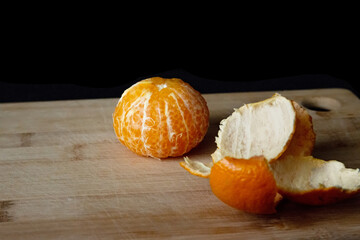 peeled tangerine on a cutting board