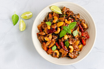Thai Stir-Fried Chickenwith Chopsticks Directly Above Photo on White Background

