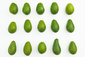 Avocado pattern on white background. Flat lay, top view. Natural diet concept.