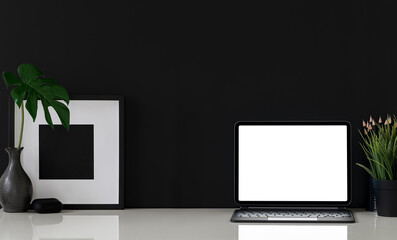Mockup blank screen tablet with keyboard and black wooden frame on white table.