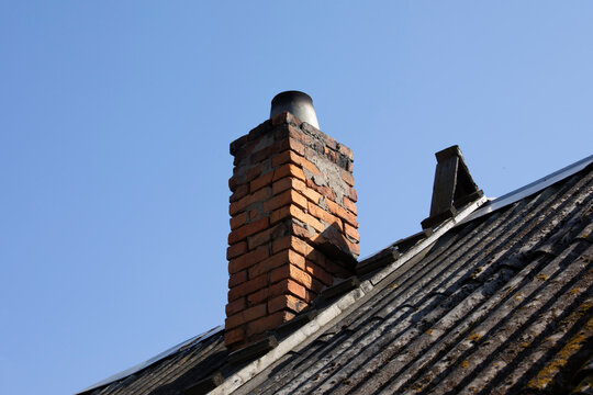 Chimney in an old village house. Brick pipe chimney