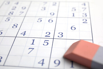 Sudoku puzzle grid and eraser, closeup view