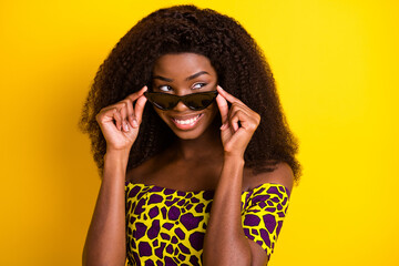 Portrait of attractive cheerful minded girl touching specs looking aside ponder isolated over...