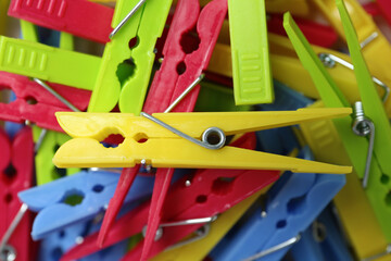 Colorful plastic clothespins as background, top view