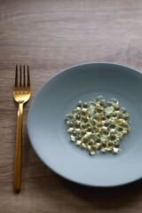 Fototapeta na wymiar Vitamin D pills on a plate. Selective focus.