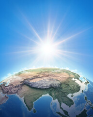 Fototapeta premium Sun shining over a high detailed view of Planet Earth, focused on East Asia, China and Himalayas. 3D illustration - Elements of this image furnished by NASA