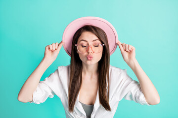 Fototapeta premium Photo of flirty charming young woman dressed white shirt glasses arms cap sending you kiss isolated teal color background