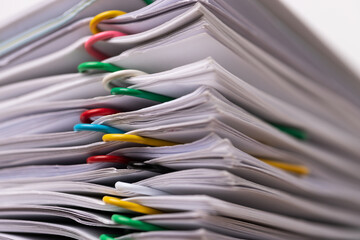 Close-up of Stack Group of report papers Document clipped in color clips, business and education concept.
