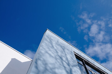 Fototapeta na wymiar part of modern building corners against blue sky