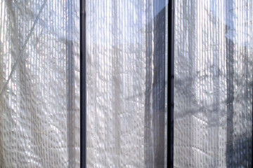 metallic striped thermal isolation curtain behind glass