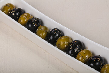 Black and green olives in the bowl