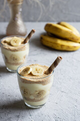 Magnolia dessert with fresh bananas in glass cup, homemade milky dessert concept