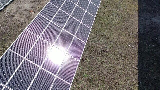 Aerial view of a solar farm producing clean renewable sun energy, industrial landscape from drone	
