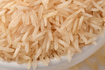 Pile of brown rice isolated on white background.