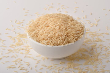 uncooked long brown rice isolated on white