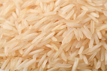 uncooked long brown rice isolated on white