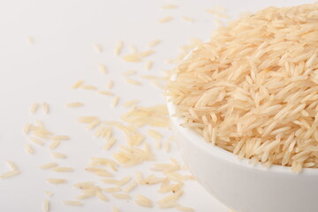 uncooked long brown rice isolated on white