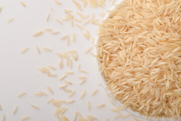 uncooked long brown rice isolated on white