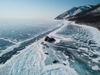 Winter top view of the coastline of Lake Baikal, the bay, the rocks and the surrounding mountains. Siberia. Russia.