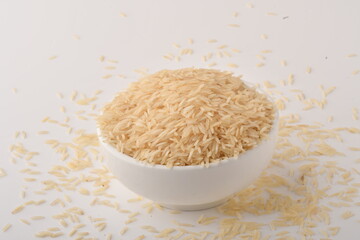 uncooked long brown rice isolated on white