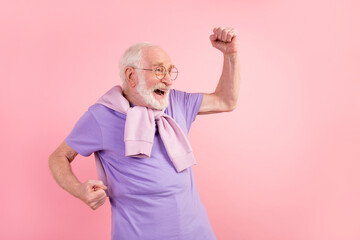 Photo portrait of pensioner smiling overjoyed gesturing like winner isolated on pastel pink color...