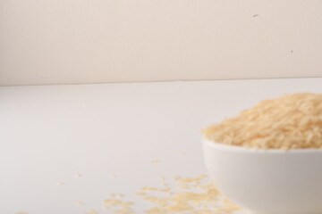 uncooked long brown rice isolated on white
