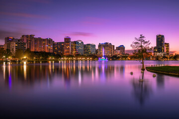Naklejka na ściany i meble Colorful sunset above Lake Eola and city skyline in Orlando, Florida