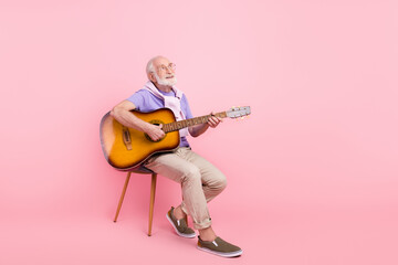 Full length body size dreamy grandpa playing guitar looking copyspace isolated on pastel pink color...