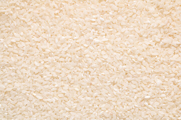 Raw white rice grain food background. Healthy eating. Top view.