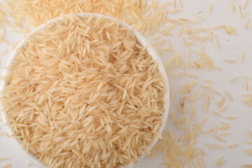 uncooked long brown rice isolated on white