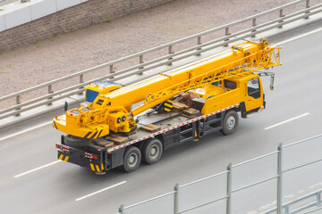 Mobile crane truck driving on the highway.